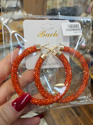 Orange Rhinestone Hoop Earrings gold clasps live hand shot of earrings in their wrapper