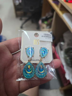 Aqua crystal glitter teardrop drop earrings on gold shown here in its package on a real hand