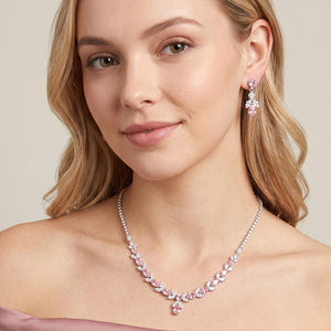 Model wearing Pink and clear crystal delicate necklace set on silver with alternating marquise stones, a small center drop, and matching drop earrings.