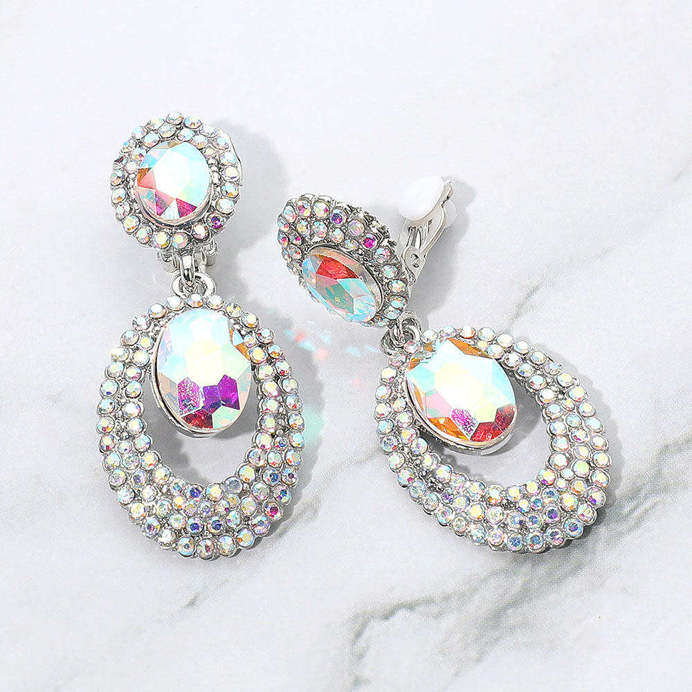 AB stone oval double-halo crystal clip-on earrings on silver on a white marble background — 2.1" silver statement drops for evening or pageant glam.