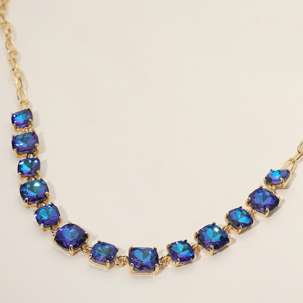 Necklace with square darker blue AB gemstones on a white background