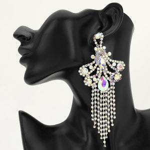 A large ornate AB crystal statement earring on silver with cascading bead fringe and iridescent crystal accents on a black earring mannequin.