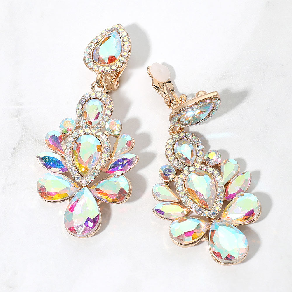 Gold-tone chandelier clip-on earrings with AB teardrop and oval faceted crystals surrounded by smaller clear rhinestones, displayed on a white marble surface.