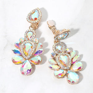 Gold-tone chandelier clip-on earrings with AB teardrop and oval faceted crystals surrounded by smaller clear rhinestones, displayed on a white marble surface.