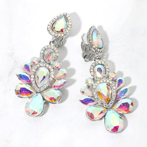 Silver-tone chandelier clip-on earrings with AB teardrop and oval faceted crystals surrounded by smaller clear rhinestones, displayed on a white marble surface.
