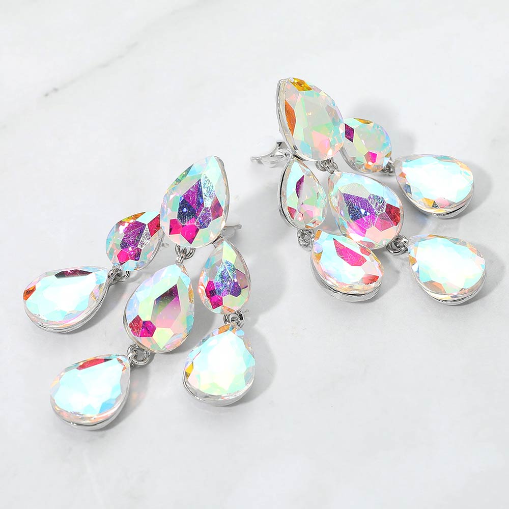 AB crystal teardrop cluster chandelier clip-on earrings on silver with iridescent stones on white marble background