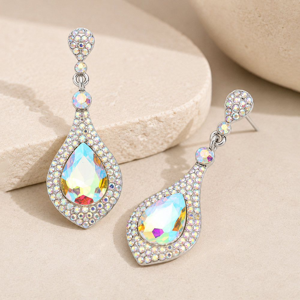 AB crystal teardrop drop earrings on silver featuring large iridescent teardrop crystals surrounded by smaller AB crystals, displayed on a neutral beige background.