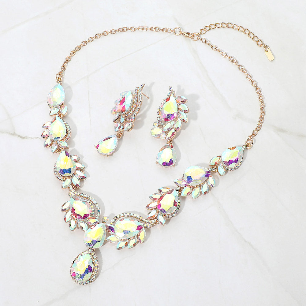 AB teardrop formal necklace and matching earrings set on gold displayed on a white background.