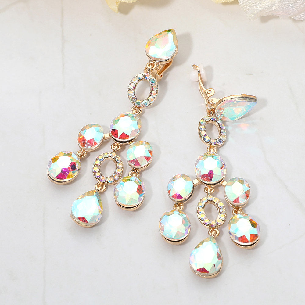 AB faceted chandelier clip-on earrings with cascading dangle stones and gold-tone setting on a marble background