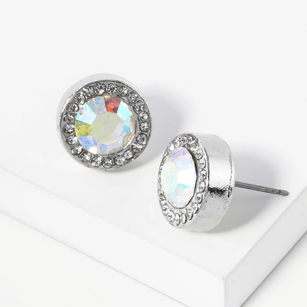 A pair of silver stud earrings with an oval AB faceted center stone surrounded by a halo of small clear rhinestones, displayed on a clean white surface.