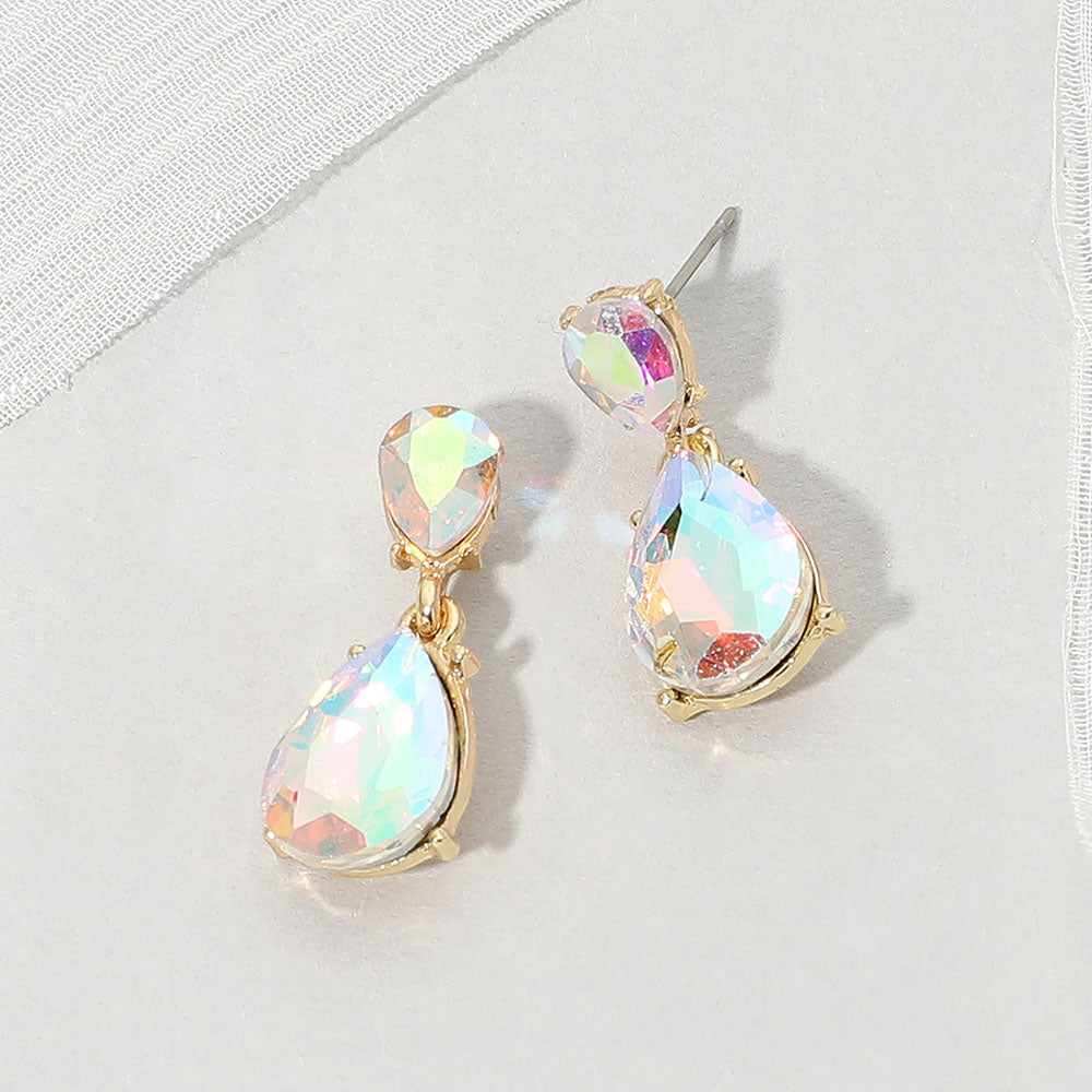 Double teardrop dangle earrings with iridescent Aurora Borealis crystals on gold, measuring 1 inch long by 0.4 inch wide, featuring smaller faceted teardrops above larger drops, displayed on a white textured surface.