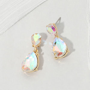 Double teardrop dangle earrings with iridescent Aurora Borealis crystals on gold, measuring 1 inch long by 0.4 inch wide, featuring smaller faceted teardrops above larger drops, displayed on a white textured surface.