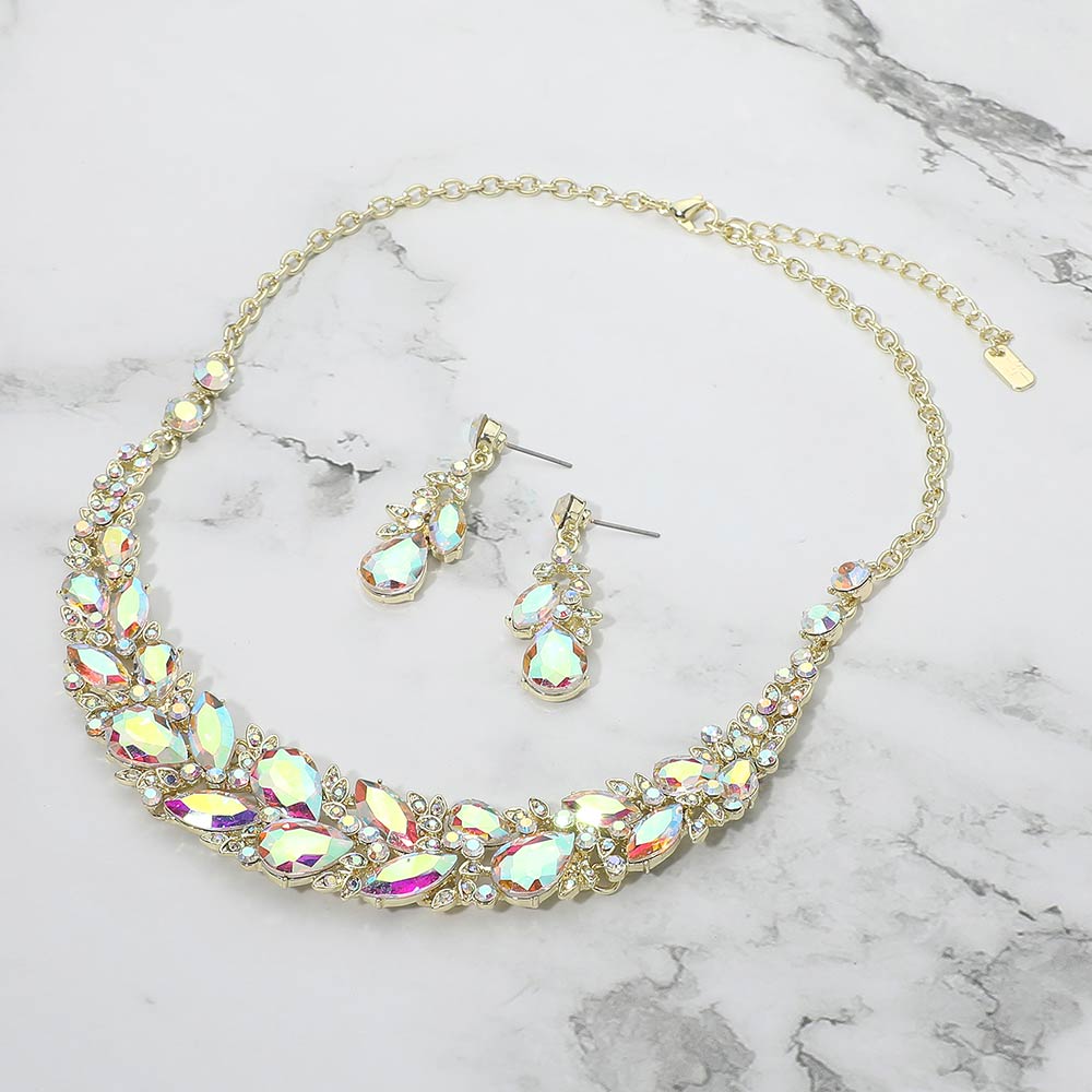 AB marquise crystal cluster necklace set on gold with matching earrings, iridescent statement jewelry for prom and evening wear on a marble background