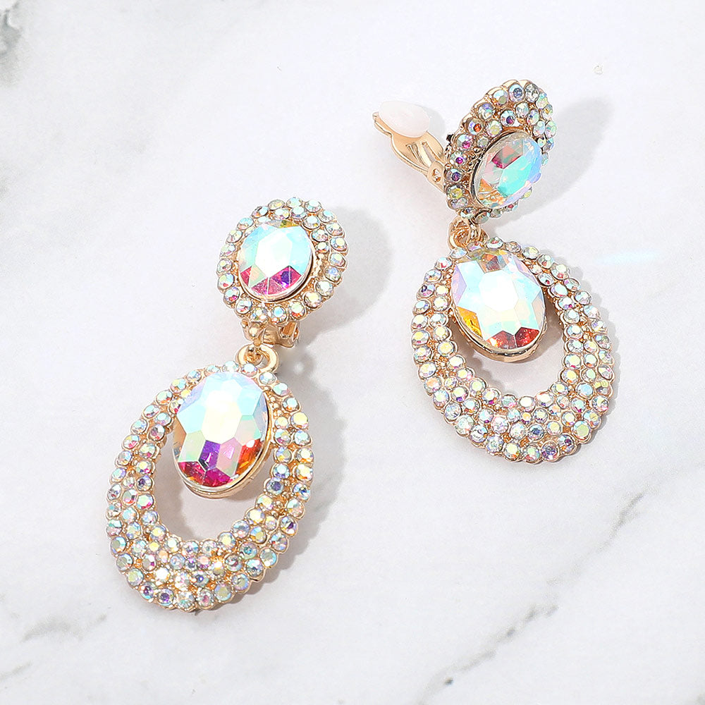 AB oval double-halo crystal clip-on earrings on gold on a white marble background — 2.1" statement drops for evening or pageant glam.
