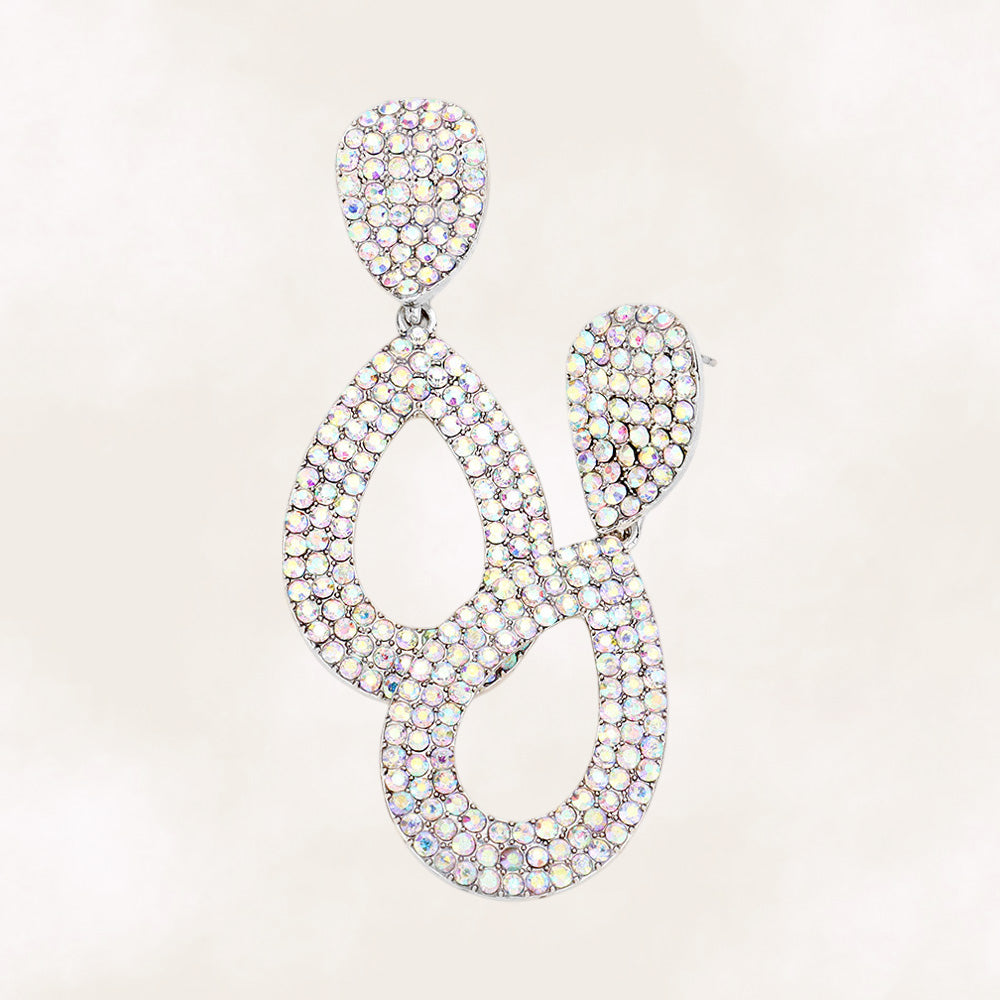 AB Aurora Borealis rhinestone pavé cut out teardrop pageant earrings on silver with iridescent crystal sparkle on beige background.