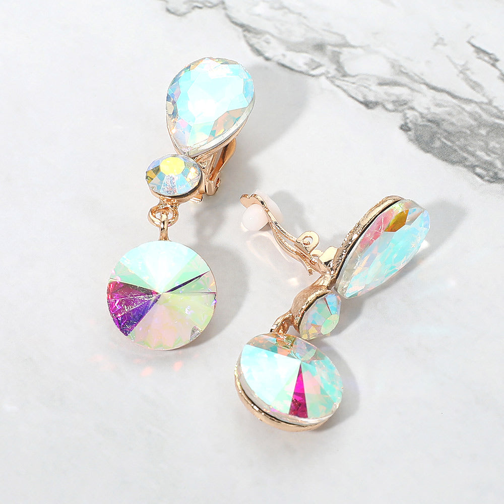 AB round crystal drop clip-on earrings on gold with iridescent stones on white marble background