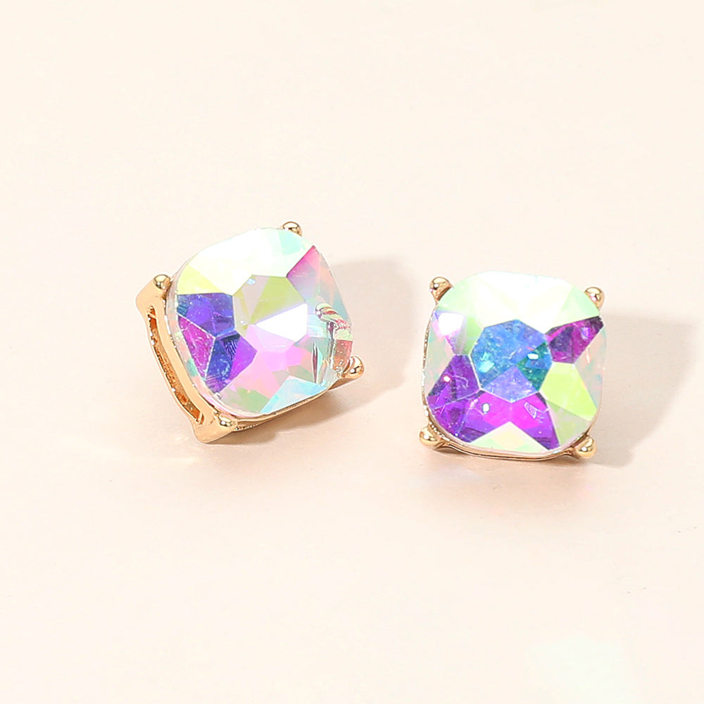 AB square cushion stud earrings on gold on light beige background