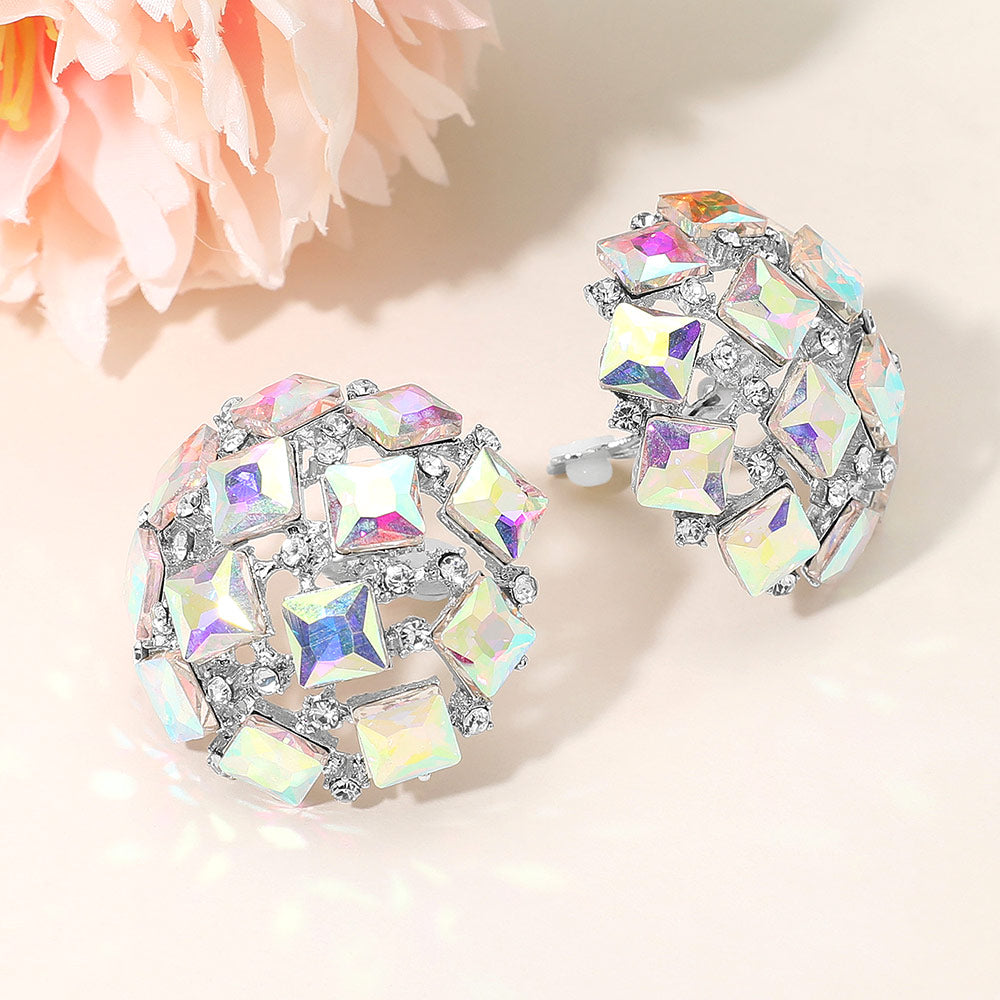 AB square stone cluster dome clip-on earrings with a geometric rhinestone design and silver-tone setting on a light background with flowers.