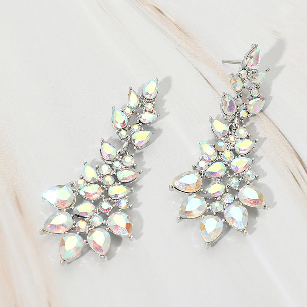 AB teardrop cluster drop earrings on silver with iridescent faceted stones on white marble background