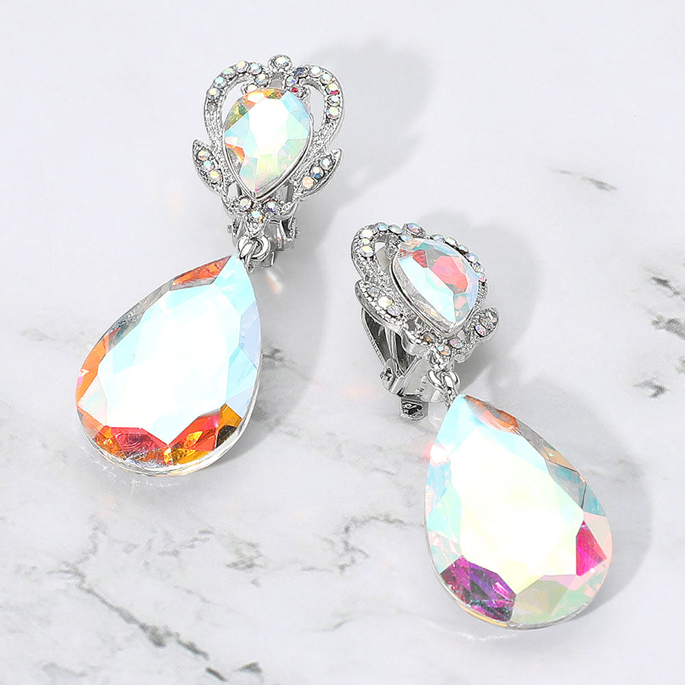 Clear faceted teardrop stone clip-on earrings on silver. Top stone is elegantly surrounded by an array of AB rhinestones in a flower like setting. 

