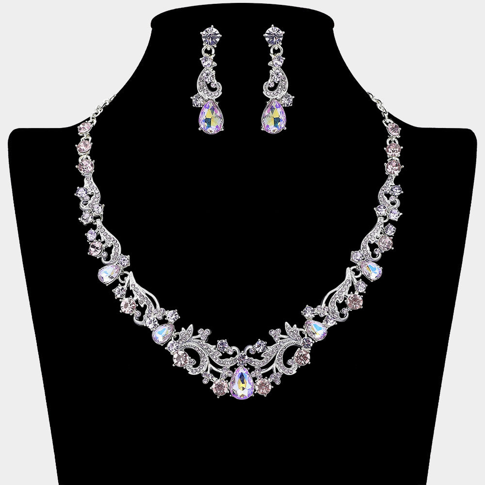Clear teardrop rhinestone cluster necklace set on silver with matching earrings for prom and formal wear. Shown here on a black mannequin bust.

