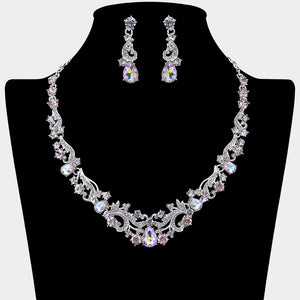Clear teardrop rhinestone cluster necklace set on silver with matching earrings for prom and formal wear. Shown here on a black mannequin bust.

