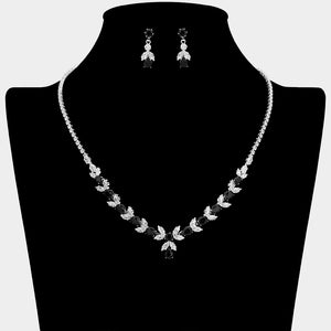 Black and clear crystal delicate necklace set on silver with alternating marquise stones, a small center drop, and matching drop earrings, displayed on a black jewelry bust.