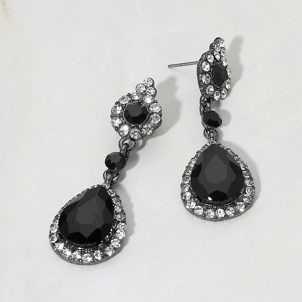 Black and clear teardrop vintage crystal drop formal and evening earrings on silver on white background