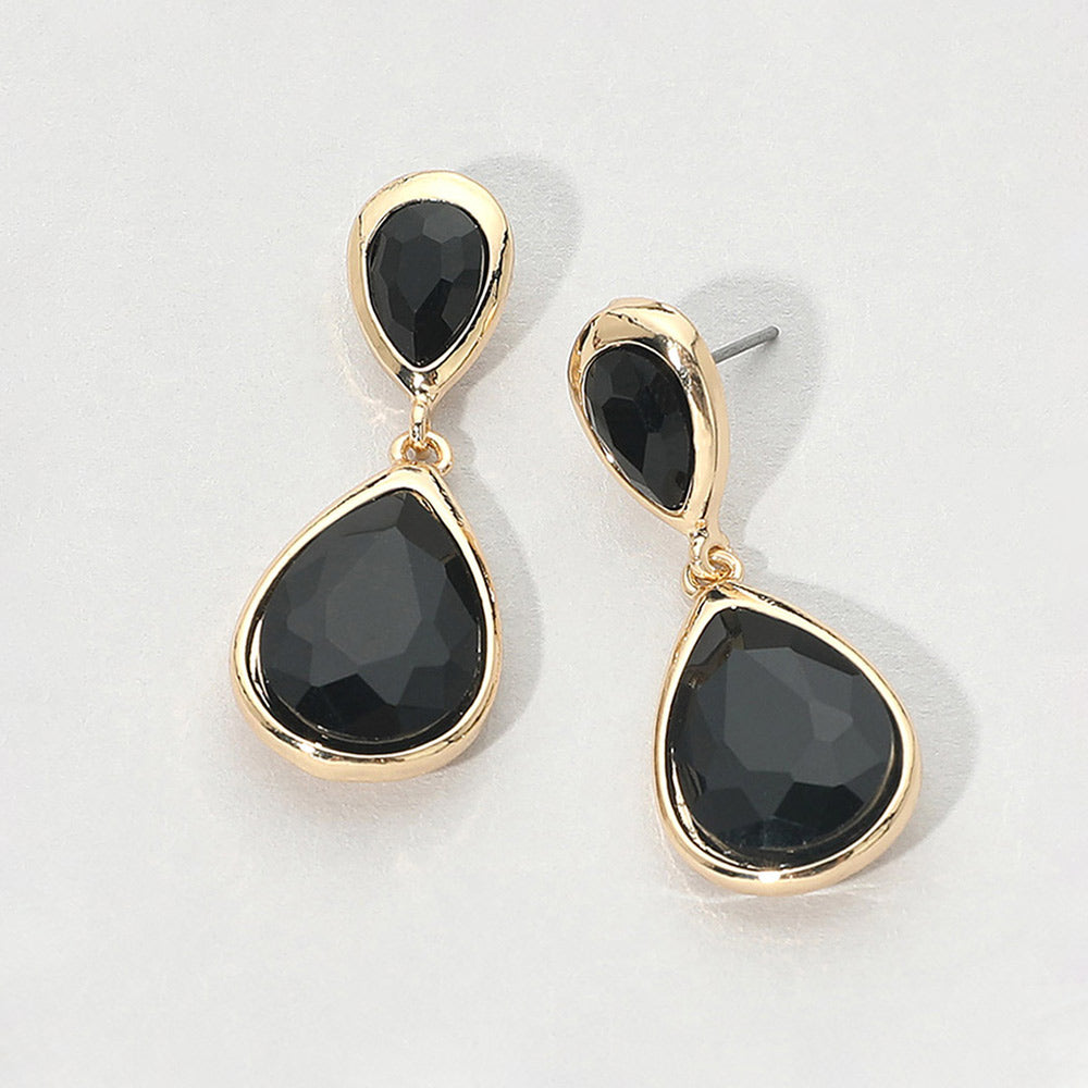Gold-tone drop earrings with faceted black double teardrop crystals, displayed on a clean white background.