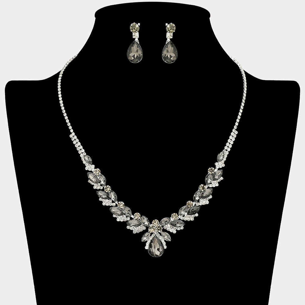 Smoky grey teardrop marquise prom necklace set on silver with matching earrings displayed on a black mannequin bust on a white background.