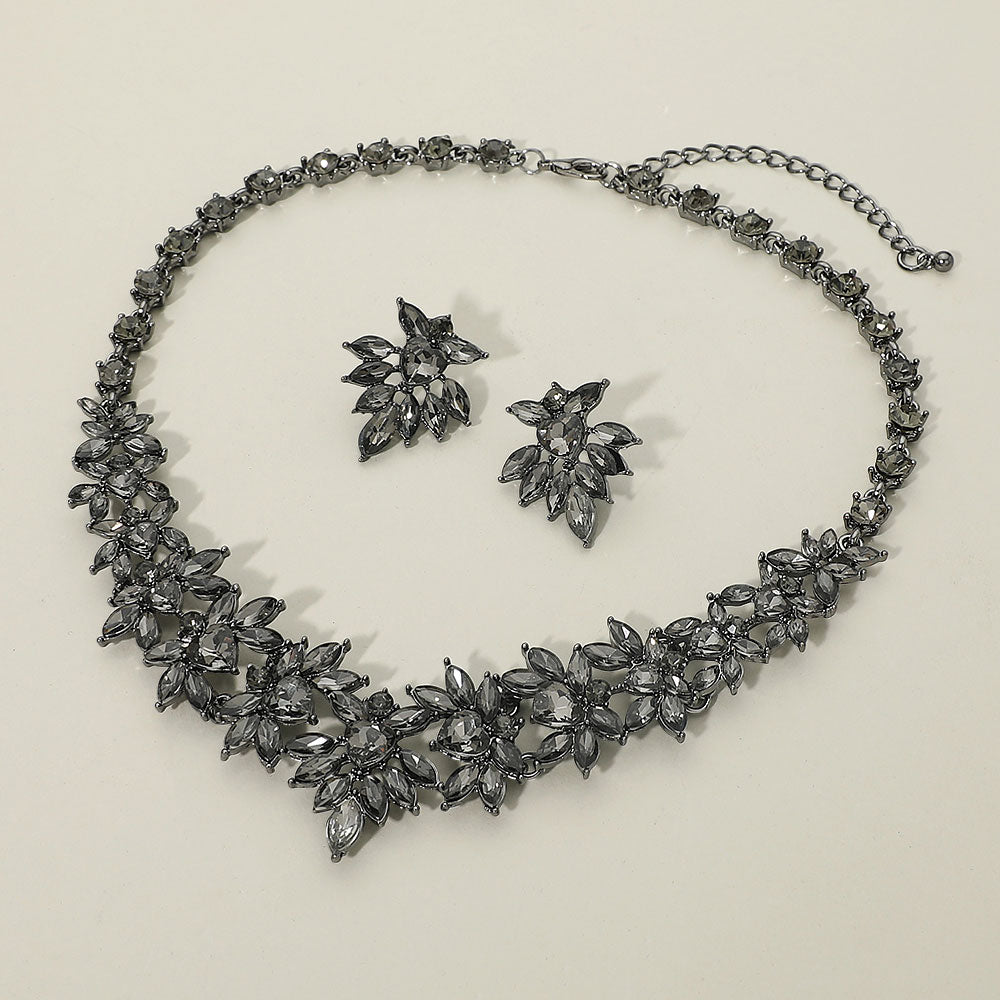 Smoky grey marquise floral statement necklace set on black on a beige background