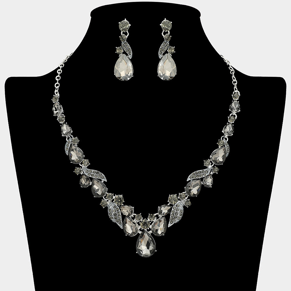 Smoky grey teardrop leaf prom necklace set on silver with matching earrings displayed on a black mannequin bust on a white background.