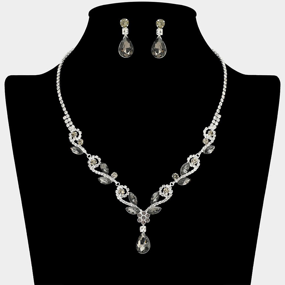 Smoky grey teardrop marquise prom necklace set on silver with matching earrings displayed on a black mannequin bust on a white background.