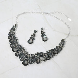 Smoky grey teardrop floral statement necklace set on silver displayed on white background