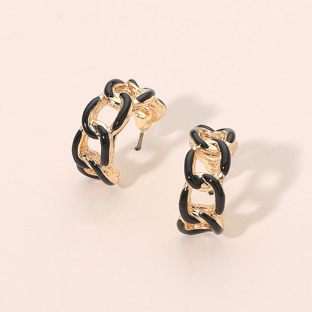Black enamel chain hoop earrings with mini linked half-hoop design and post-back closure on a beige background