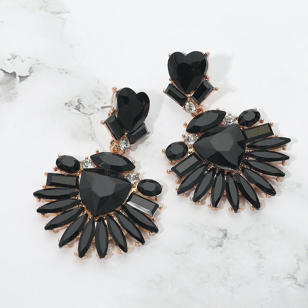 Black Heart Crystal Fan pageant and prom earrings on gold displayed on a white marble background