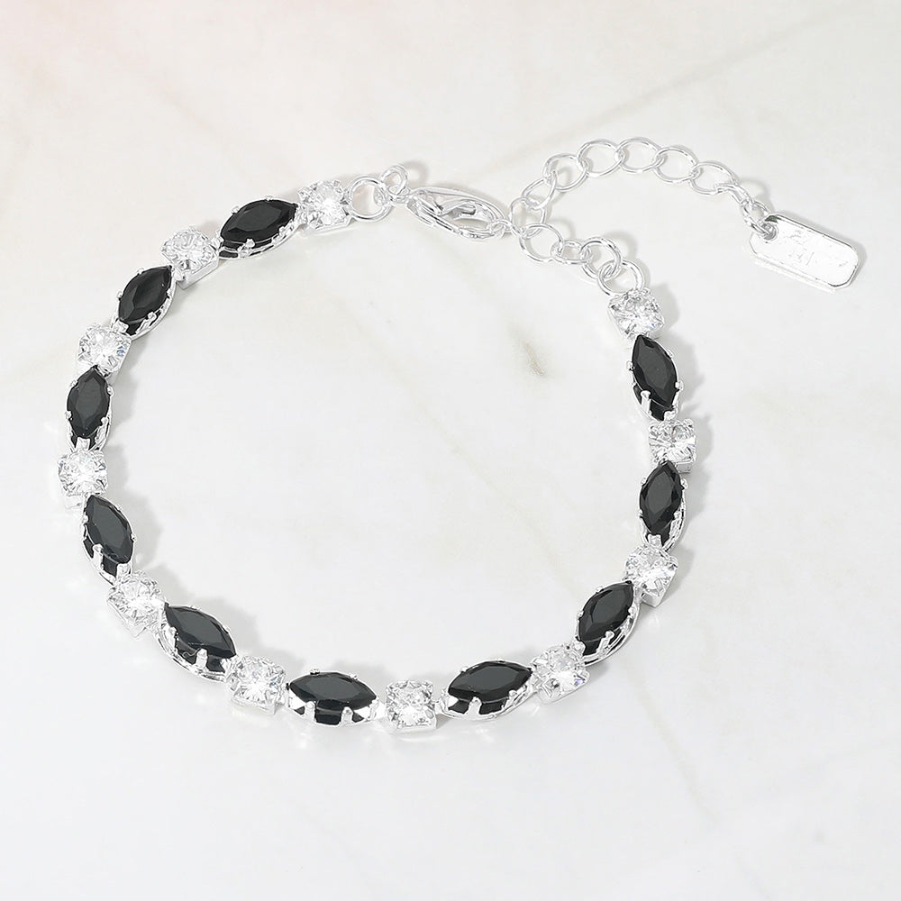 Black marquise crystal prom bracelet on silver on white marble background