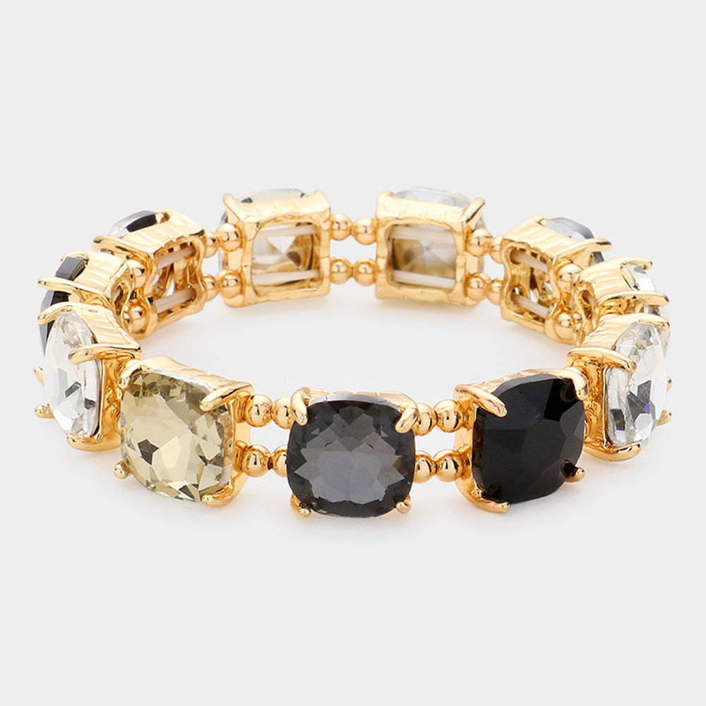 Black multi cushion square stone stretch evening bracelet on gold, bold statement bracelet for evening and special occasions on a white background
