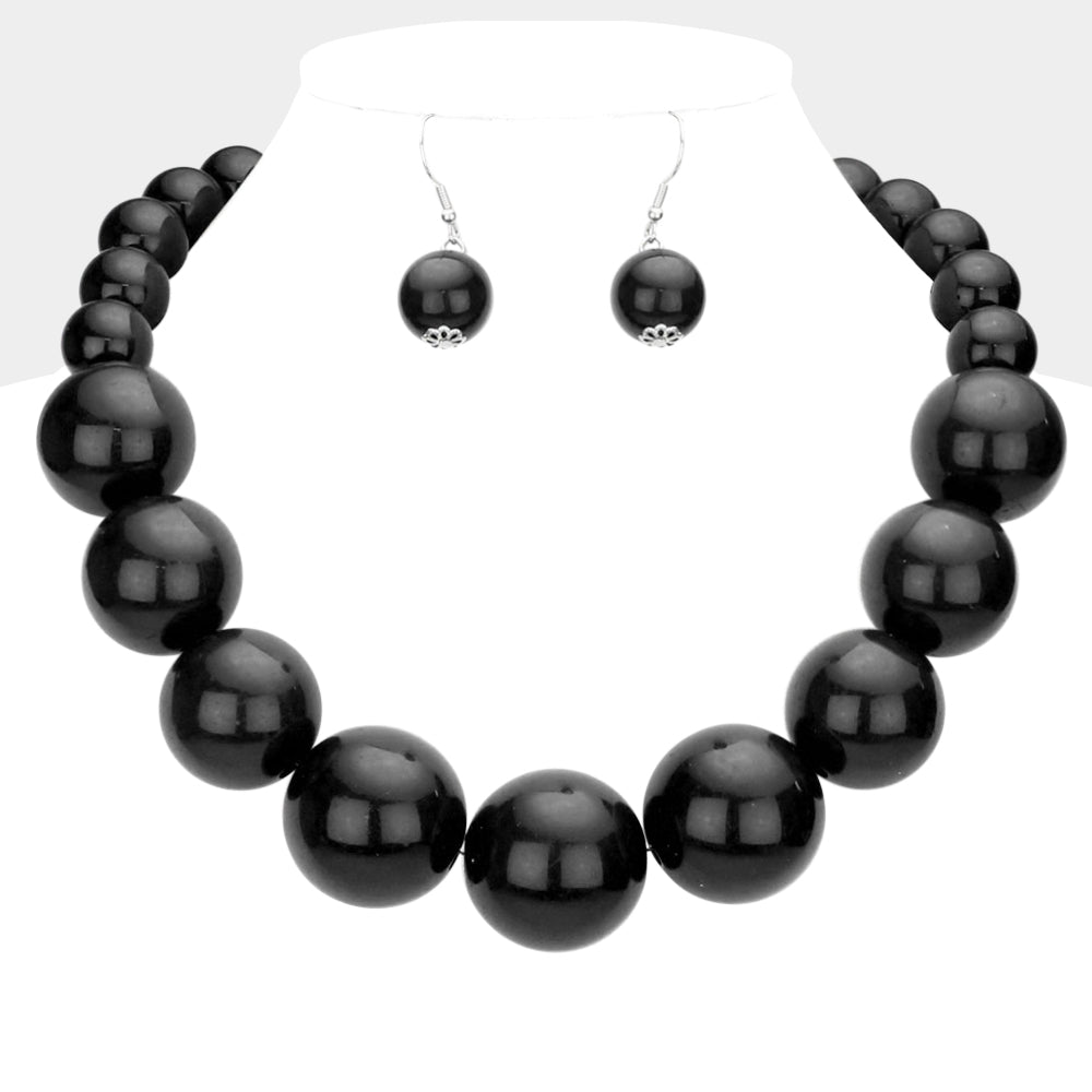 Black Oversized Graduated Pearl Glossy Statement Necklace Set on silver on a white background.