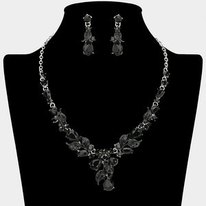 Black crystal teardrop leaf necklace and earring set on silver for formal events and pageants on a black mannequin bust on a white background.