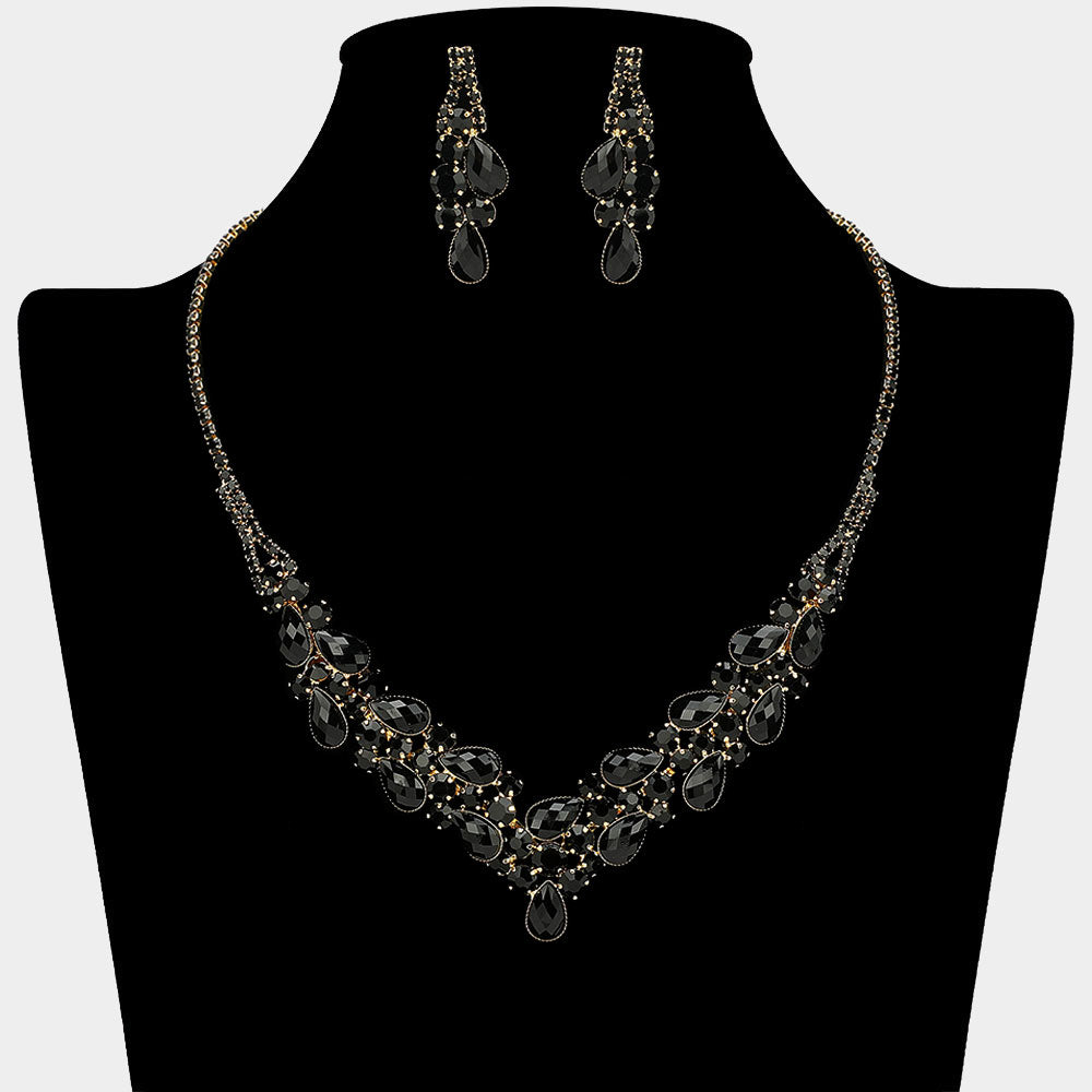 Black teardrop rhinestone necklace set with V-shaped crystal design and matching earrings, all backed in gold, for prom and formal wear. Shown on a black mannequin bust.  