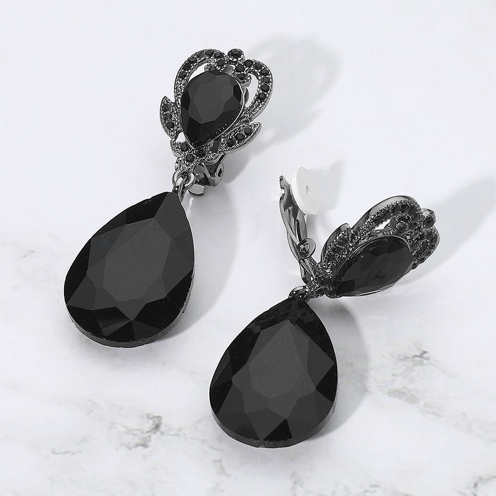 Black faceted teardrop stone clip-on earrings. Top stone is elegantly surrounded by an array of rhinestones in a flower like setting. 
