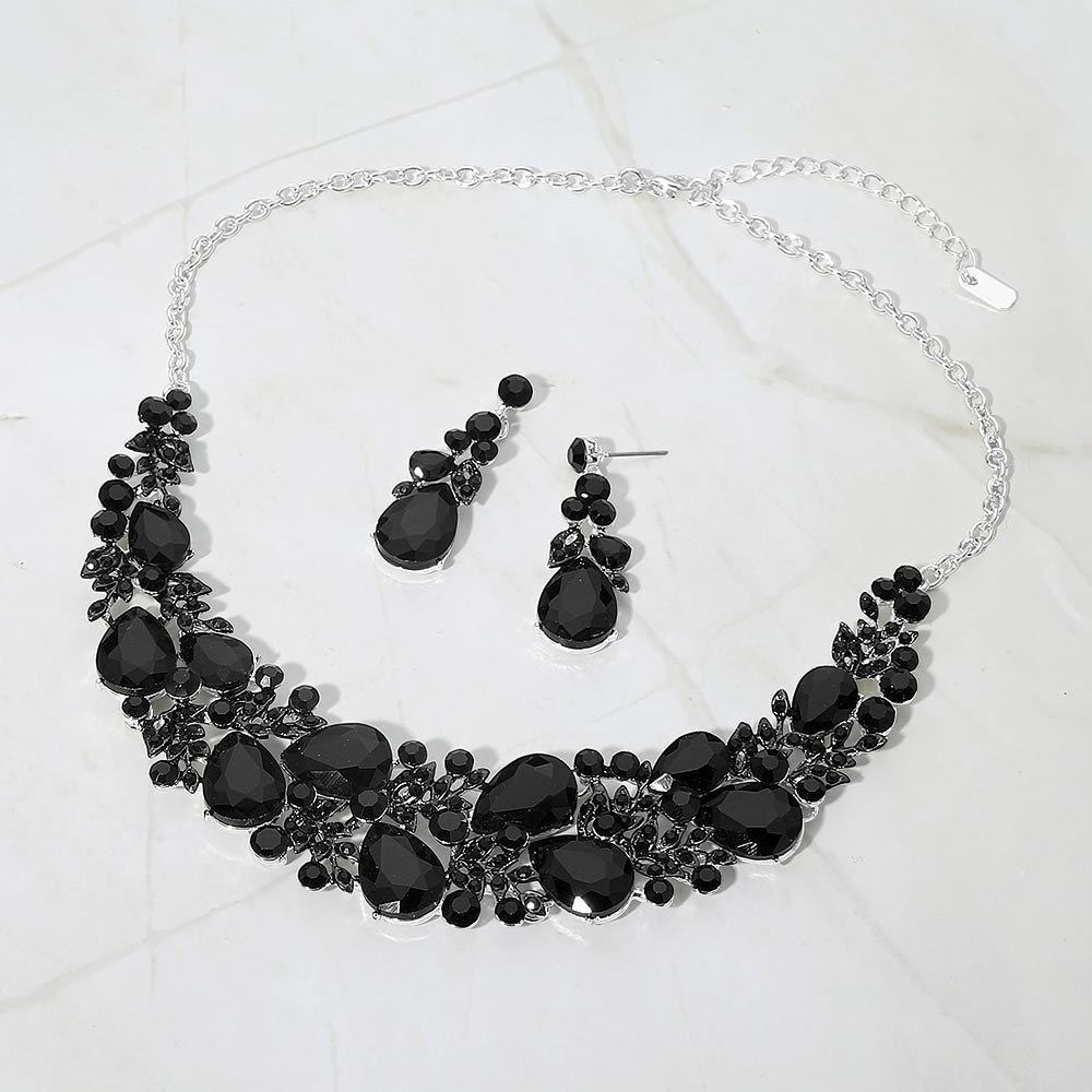 Black teardrop leaf branch statement necklace set on silver on a white marble background