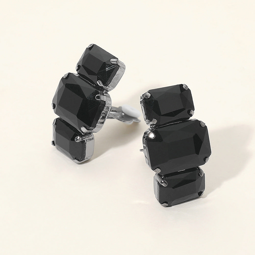 Black triple rectangular faceted stone clip-on evening earrings on a light background