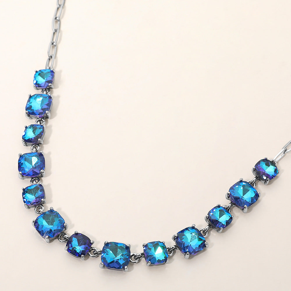 Blue Cushion Square Stone Link Pageant Necklace | Prom Necklace, antique silver backed, on a beige background. 