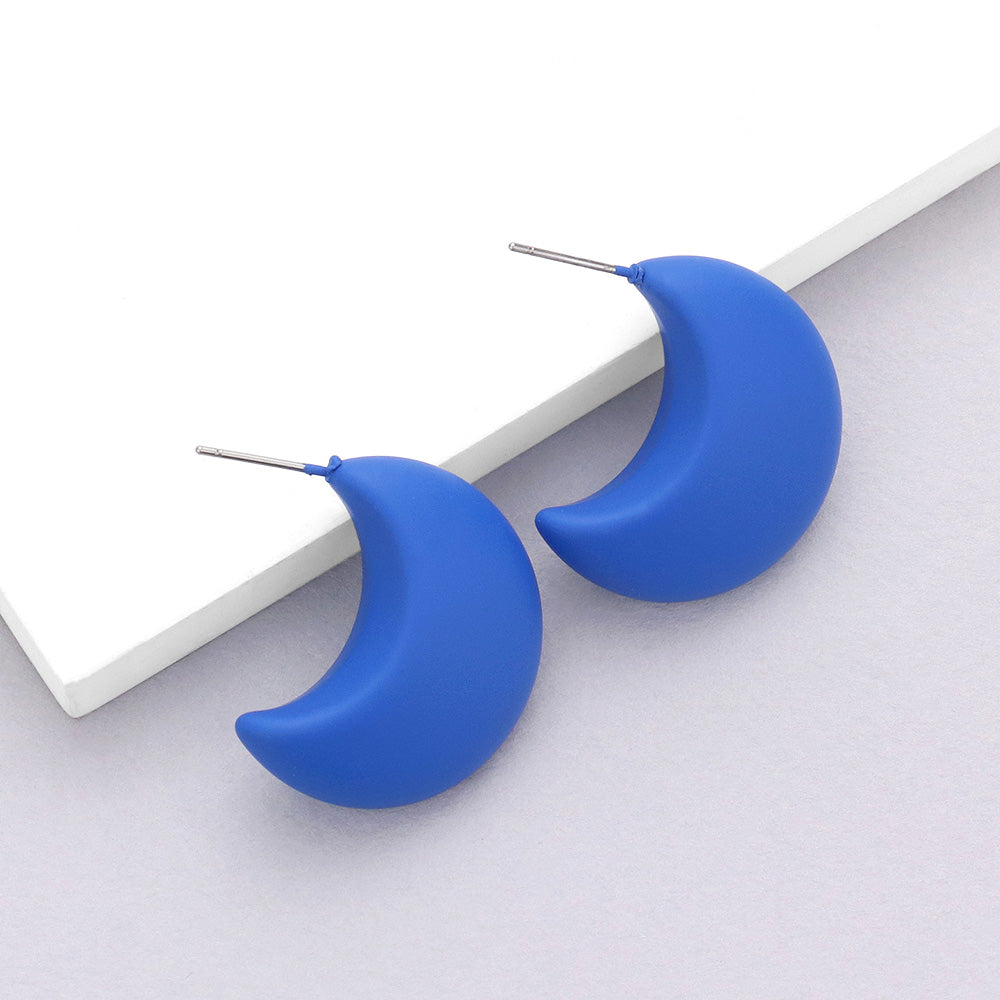 Blue matte crescent moon earrings on a white background