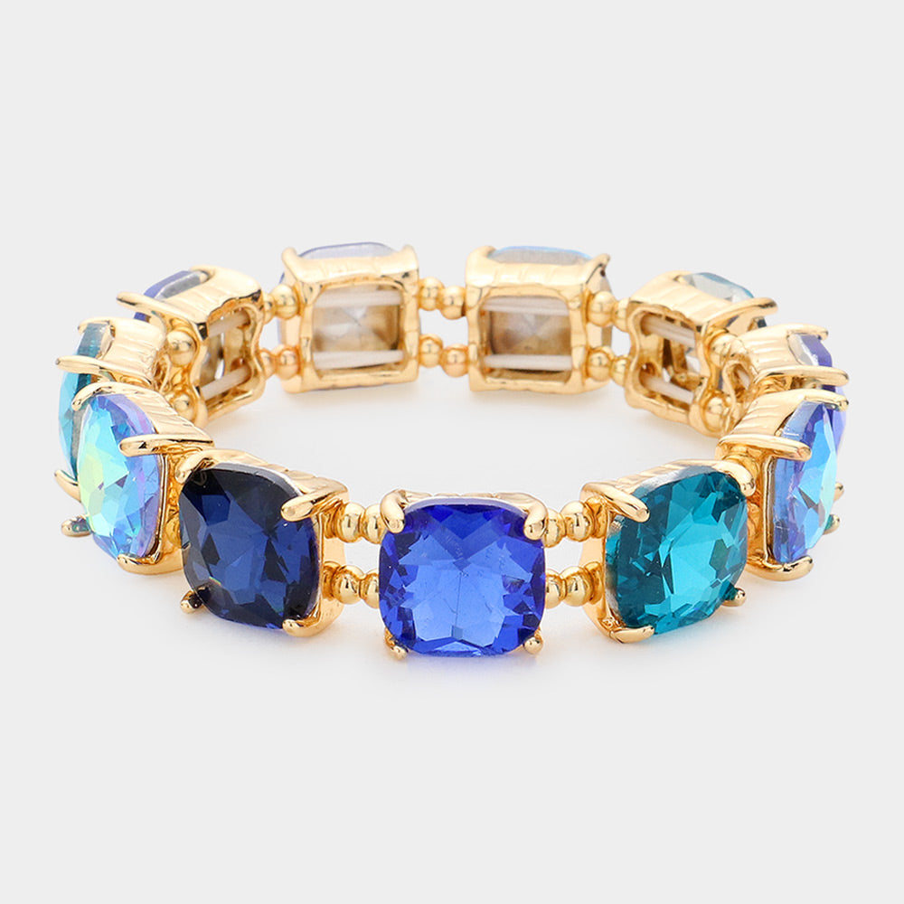 Blue multi cushion square stone stretch evening bracelet on gold, bold statement bracelet for evening and special occasions on a white background