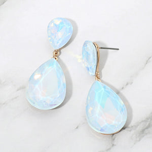 Blue opal crystal double teardrop dangle earrings on gold displayed on a white marble background.