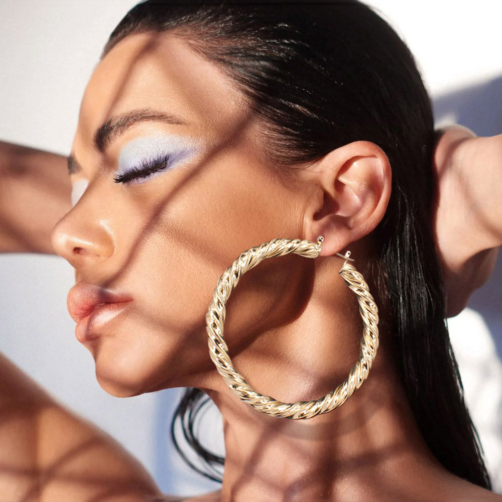 Brushed Gold Metal Twisted Hoop Pin Catch Earrings on a beautiful lady in the sun  3.2" 