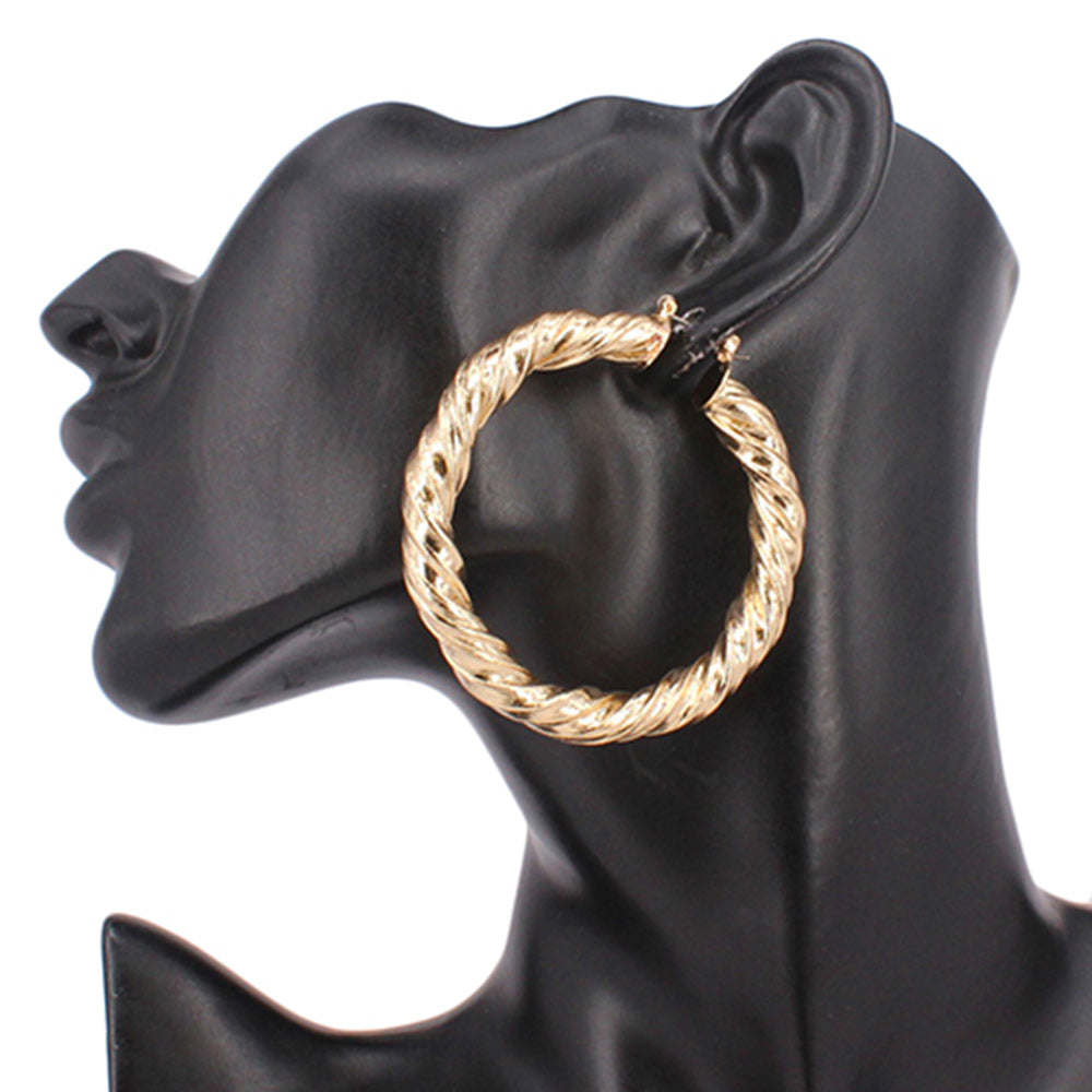A gold metal twisted hoop pin catch earring displayed on a mannequin ear. 2.4"